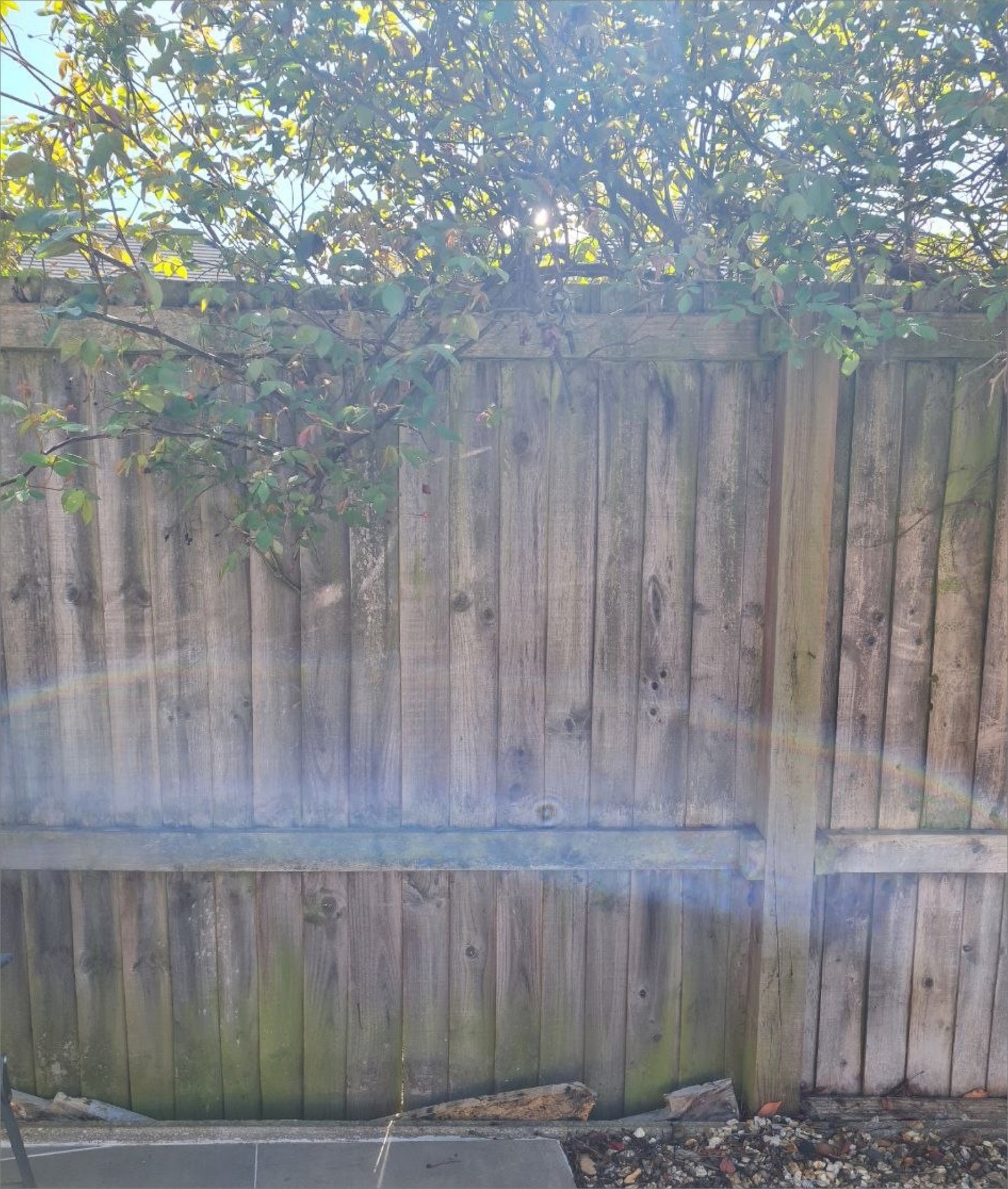 Weathered wooden fence before any paint has been applied